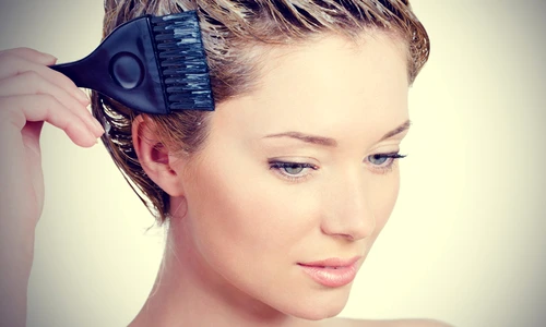 woman is coloring her hair at home jpeg