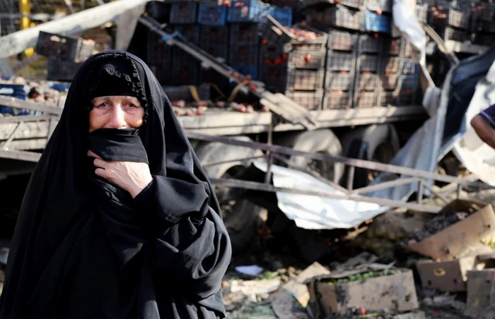 O irakiankă plânge în timp ce priveşte locul unui atac cu bombă din piaţa Jameela FOTO Arhivă