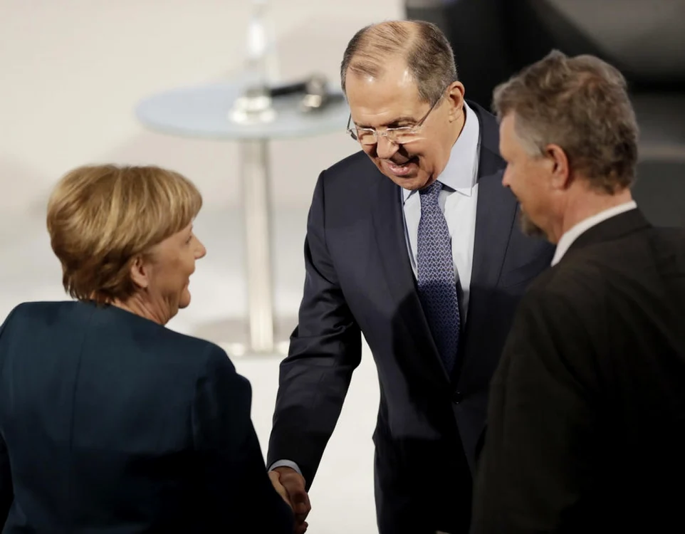 Cancelarul german Angela Merkel dă mâna cu şeful diplomaţiei rus, Serghei Lavrov