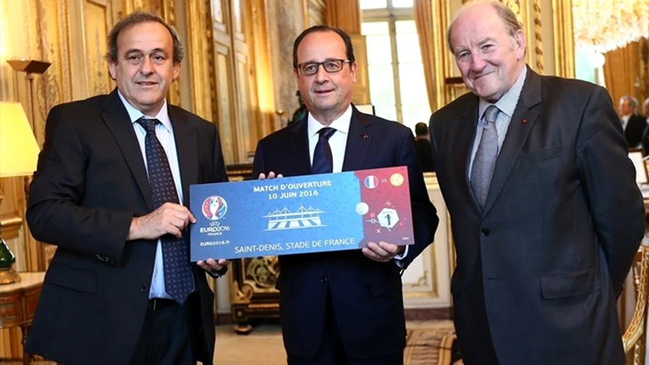 
    Michel Platini, preşedintele UEFA, François Hollande, preşedintele Franţei şi Jacques Lambert, preşedintele comitetului de organizare a Euro 2016 prezintă biletul la meciul de deschidere, Franţa - RomâniaUEFA.com  
