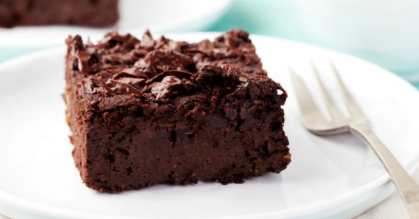 Chocolate brownie, cake on a white plate on a turquoise wooden background jpeg