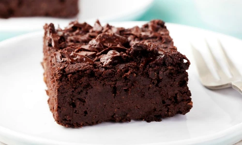 Chocolate brownie, cake on a white plate on a turquoise wooden background jpeg