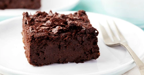 Chocolate brownie, cake on a white plate on a turquoise wooden background jpeg