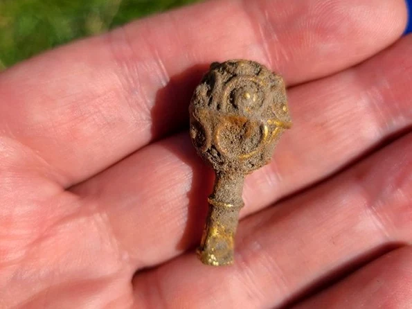 Obiectul din aur are doar 4 centimetri lungime și este modelat sub forma unui mic buton (© Facebook / Newcastle University)