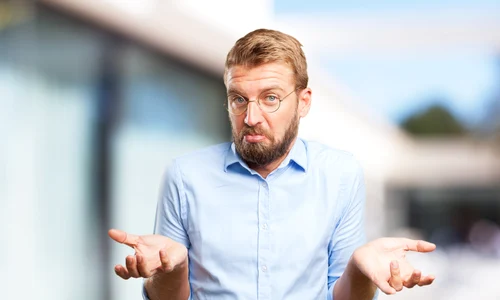 confused businessman with blurred background jpg
