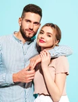 sexy smiling beautiful woman her handsome boyfriend happy cheerful family having tender moments near blue wall studiopure cheerful models huggingembracing each other jpg