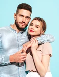 sexy smiling beautiful woman her handsome boyfriend happy cheerful family having tender moments near blue wall studiopure cheerful models huggingembracing each other jpg