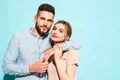 sexy smiling beautiful woman her handsome boyfriend happy cheerful family having tender moments near blue wall studiopure cheerful models huggingembracing each other jpg