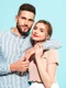 sexy smiling beautiful woman her handsome boyfriend happy cheerful family having tender moments near blue wall studiopure cheerful models huggingembracing each other jpg