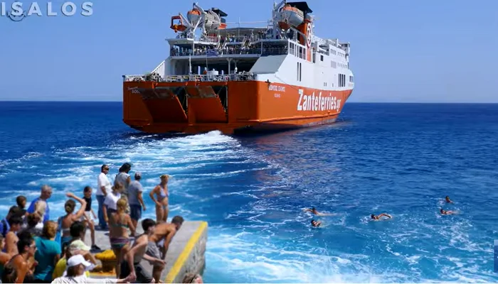 Localnicii se aruncă în mare, în urma turiștilor. FOTO Captură YouTube / Isalos