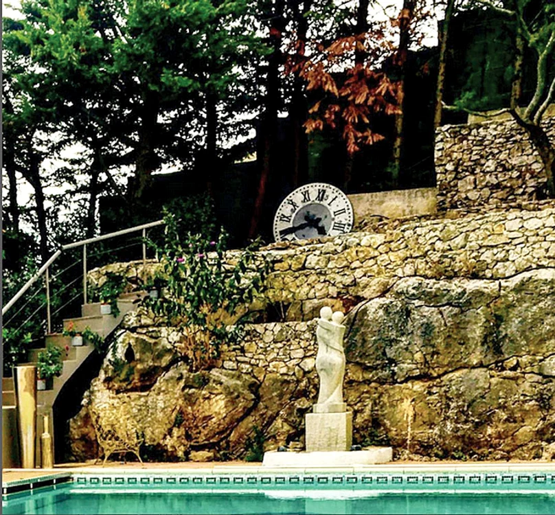 O statuie cu doi îndăgostiţi şi un ceas imens o însoţesc pe Mihaela la piscină