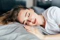 beautiful young brunette woman sleeping white bed jpg