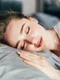 beautiful young brunette woman sleeping white bed jpg