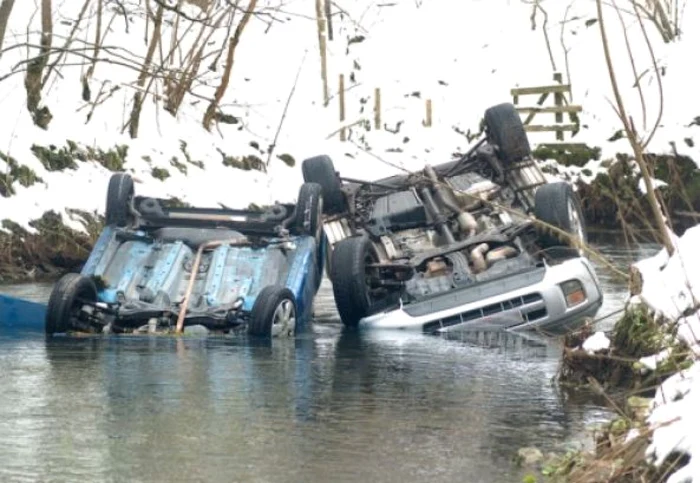 Maşinile celor doi soţi s-au răsturnat în acelaşi loc după ce au derapat