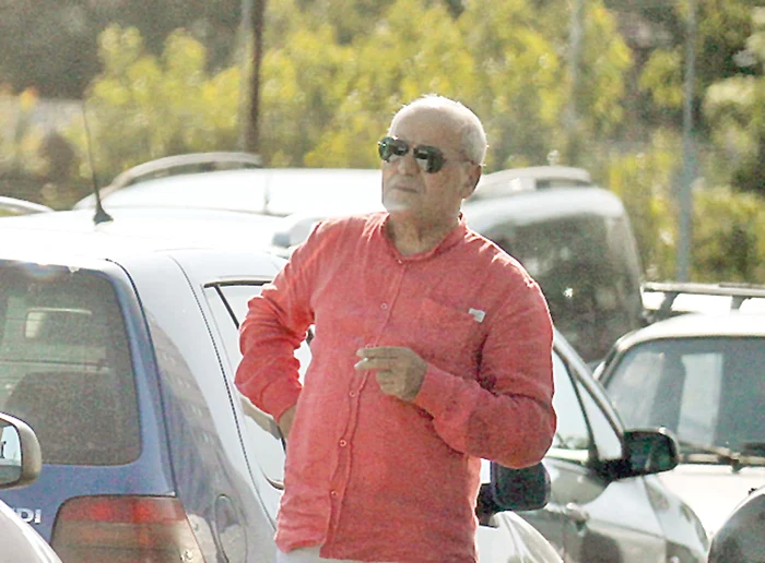 I-a aşteptat pe indivizi în parcarea  unui supermarket,  fumând nervos