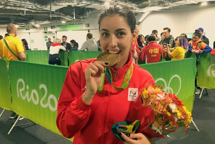 Loredana Dinu la Jocurile Olimpice de la Rio de Janeiro 2016 mușcând din medalie