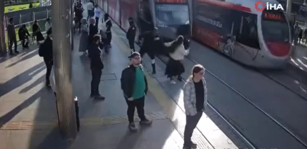 Momentul în care un agent de pază salvează în ultima secundă o femeie din fața tramvaiului