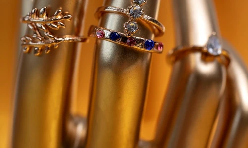 gold aesthetic wallpaper with hand wearing rings jpg