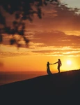 romantic couple holding hands shore sea sunset jpg