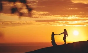 romantic couple holding hands shore sea sunset jpg