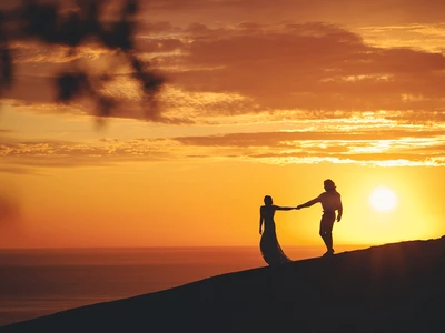romantic couple holding hands shore sea sunset jpg