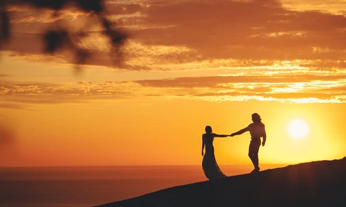 romantic couple holding hands shore sea sunset jpg