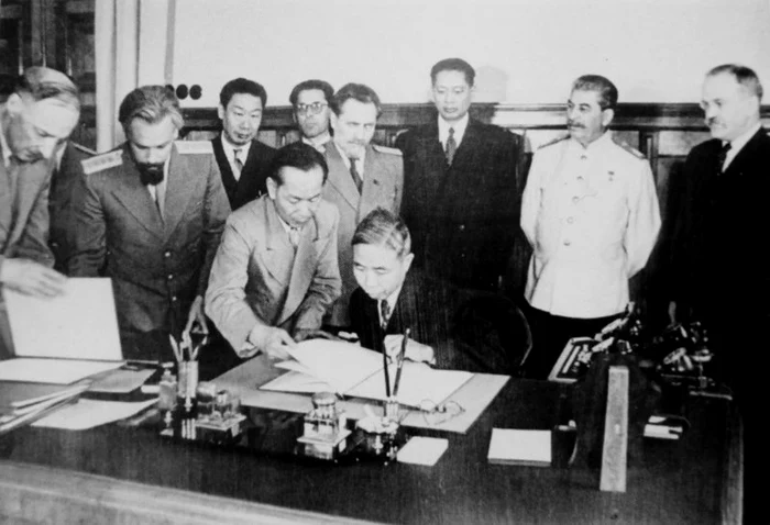 A group of people standing around a tableDescription automatically generated with medium confidence