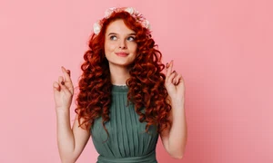 young girl with red hair flowers her head crosses fingers portrait blue eyed woman green dress pink space jpg