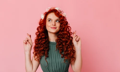 young girl with red hair flowers her head crosses fingers portrait blue eyed woman green dress pink space jpg