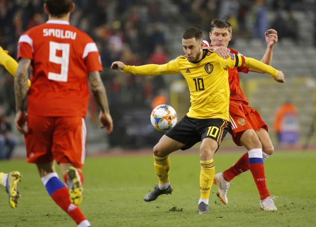 Eden Hazard protejează balonul în fața rusului Kiril NababkinFoto: EPA