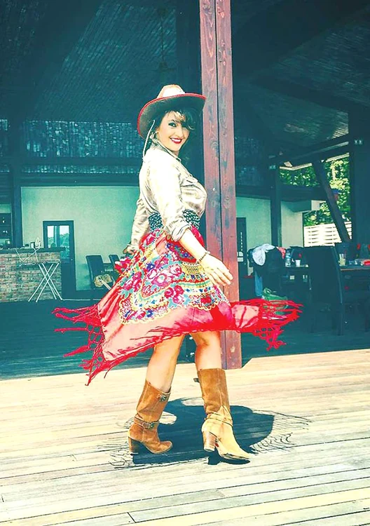 Rona Hartner  a combinat cămașa  de armată cu o  fustă țigănească,  cizme și pălărie  de cowboy