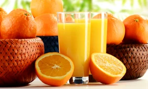 9110288   two glasses of orange juice and fruits jpeg