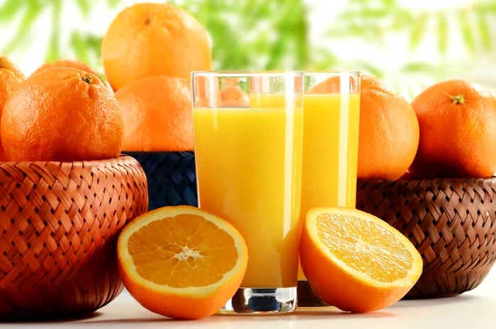 9110288   two glasses of orange juice and fruits jpeg