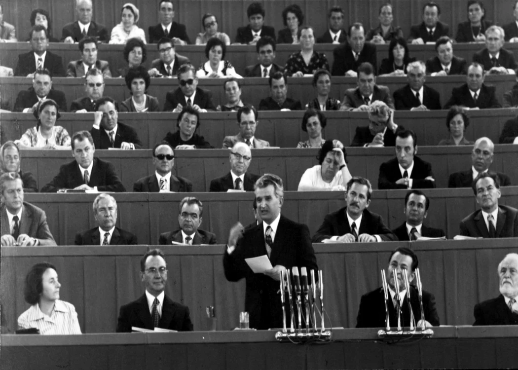 Nicolae Ceauşescu vorbind la la Congresul consiliilor de conducere din agricultură, 18-20 aprilie 1977. În plan secund, al doilea din dreapta, Ion Iliescu ascultă atent discursul preşedintelui. FOTO: Arhivele Naţionale
