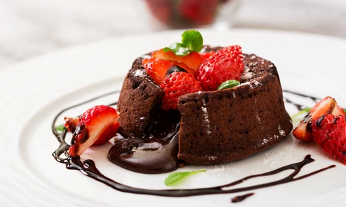 Chocolate fondant (cupcake) with strawberries and powdered sugar jpeg