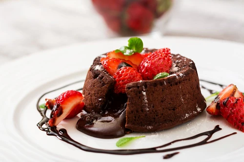 Chocolate fondant (cupcake) with strawberries and powdered sugar jpeg