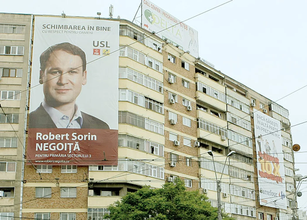 Robert Negoiţă are afişe imense.  Pe mai multe blocuri din  sectorul 3 este afişat chipul său,  cu o freză de copil cuminte. Afişul din  imagine se întinde pe şase etaje