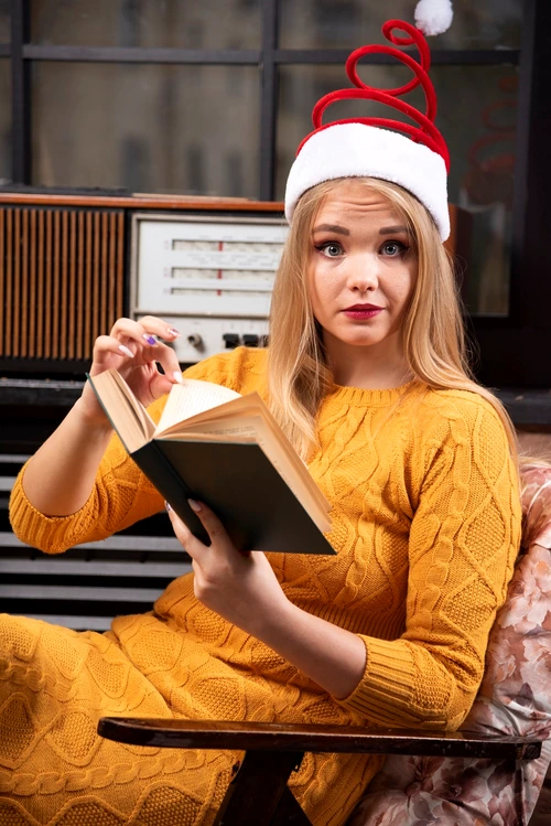 young woman santa s hat sitting with opened book jpg
