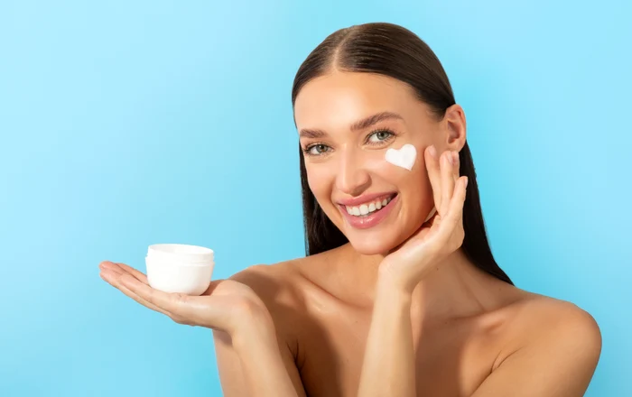 happy lady holding jar applying moisturizing cream enjoy new skin hydration product posing jpg