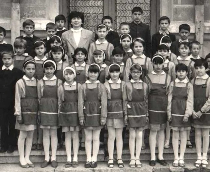 Părul elevelor trebuia strâns în codiţe împletite şi prins cu funde albe, bretonul prins sub bentiţa din bumbac, tot albă, care înconjura capulFOTO: historia.ro