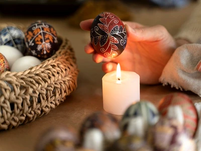 woman decorating easter eggs jpg