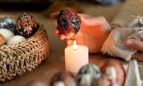 woman decorating easter eggs jpg