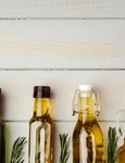 glass bottle with olive oil gray background (2) jpg