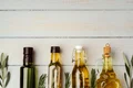 glass bottle with olive oil gray background (2) jpg