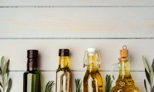 glass bottle with olive oil gray background (2) jpg
