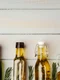 glass bottle with olive oil gray background (2) jpg