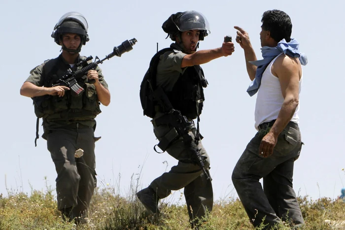 Un palestinian înfruntă doi soldaţi evrei