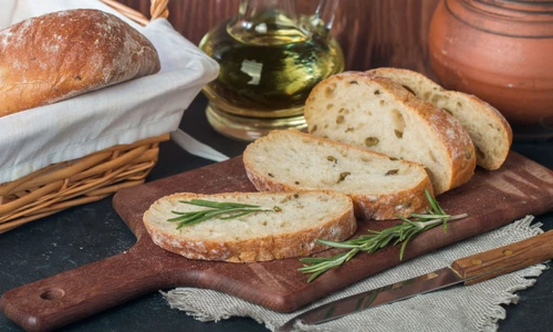 41507339   sliced bread ciabatta and rosemary on wooden background jpeg