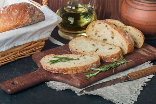 41507339 sliced bread ciabatta and rosemary on wooden background jpeg