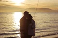 couple with heart balloon hugging sea shore evening jpg